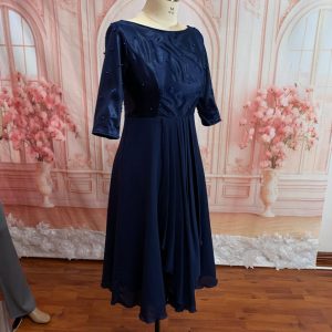 Boatneck with pearl detail. Fitted bodice. Three-quarter sleeve Theron's Fashion and Bridal Boutique