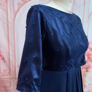 Fitted bodice. Three-quarter sleeves Theron's Fashion and Bridal Boutique